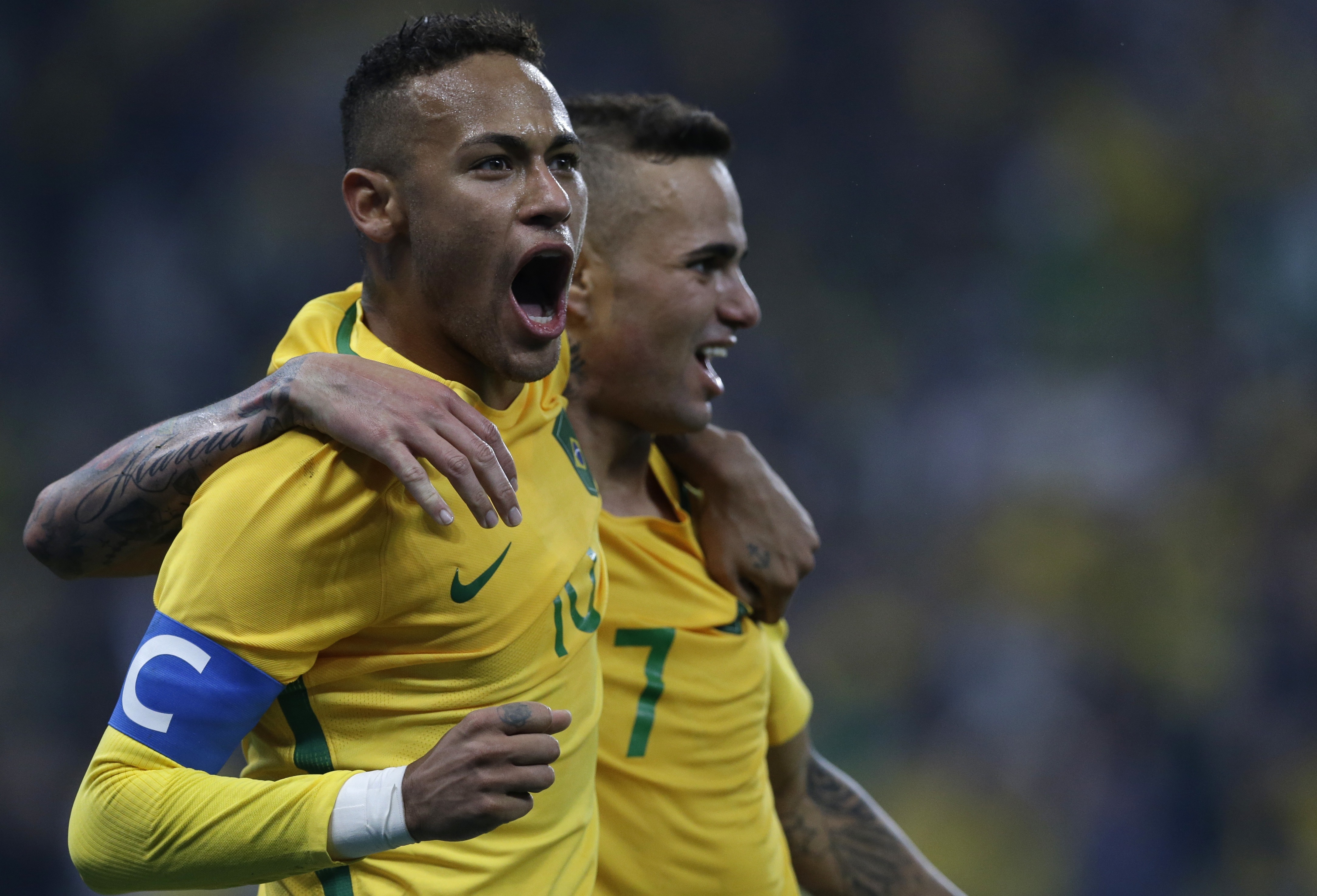 Brazil's Luan, right, celebrates with teammate Neymar after scoring his team's second goal during a quarter-final match of the men's Olympic football tournament between Brazil and Colombia in Sao Paulo, Brazil, Saturday Aug. 13, 2016.(AP Photo/Leo Correa)