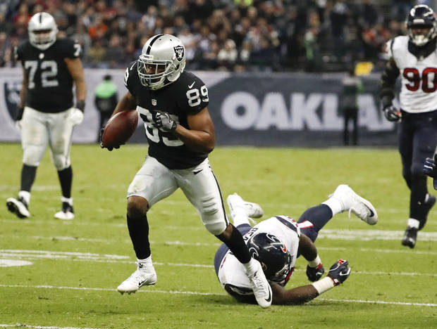 Oakland Raiders wide receiver Amari Cooper breaks away from Houston Texans defensive end D.J. Reader on his way to scoring a touchdown during the second half of an NFL football game Monday, Nov. 21, 2016, in Mexico City. (AP Photo/Eduardo Verdugo)