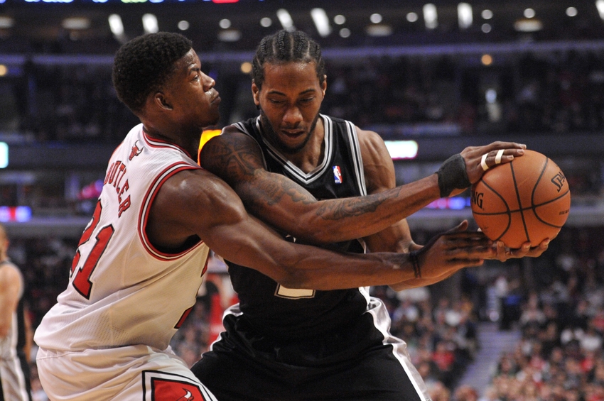 Mar 11, 2014; Chicago, IL, USA; San Antonio Spurs small forward Kawhi Leonard (2) is defended by Chicago Bulls shooting guard Jimmy Butler (21) during the first quarter at the United Center. Mandatory Credit: Rob Grabowski-USA TODAY Sports