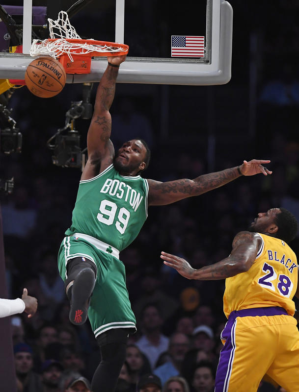 Boston Celtics forward Jae Crowder, left, dunks as Los Angeles Lakers center Tarik Black defends during the first half of an NBA basketball game, Friday, March 3, 2017, in Los Angeles. (AP Photo/Mark J. Terrill)
