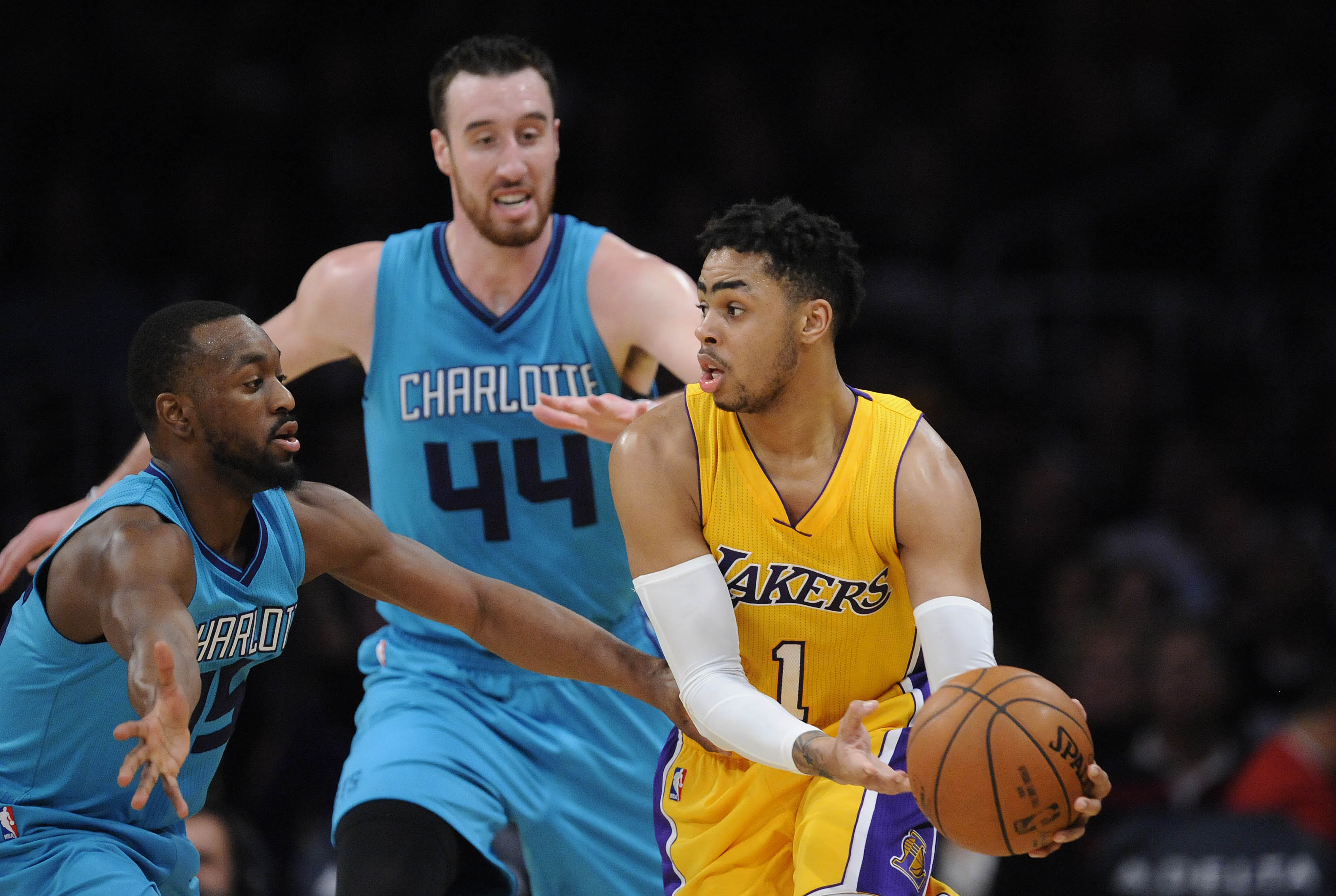 February 28, 2017; Los Angeles, CA, USA; Los Angeles Lakers guard D'Angelo Russell (1) controls the ball against Charlotte Hornets guard Kemba Walker (15) and center Frank Kaminsky III (44) during the first half at Staples Center. Mandatory Credit: Gary A. Vasquez-USA TODAY Sports