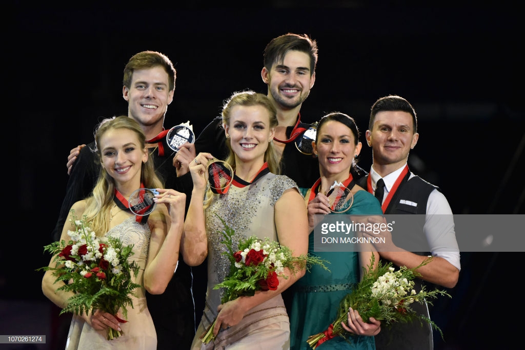 Ice dance category gold medalists USA's Madison Hubbell and Zachary Donohue (C), silver medalists Russia's Victoria Sinitsina and Nikita Katsalapov (L) and bronze medalists Italy's Charlene Guignard and Marco Fabbri (R) at the ISU Grand Prix of Figure Skating Final 2018-19 on December 8, 2018 in Vancouver, British Columbia, Canada. - The event is taking place from December 6-9 in Vancouver, B.C., at the Doug Mitchell Thunderbird Sports Centre. (Photo by Don MacKinnon / AFP)        (Photo credit should read DON MACKINNON/AFP/Getty Images)